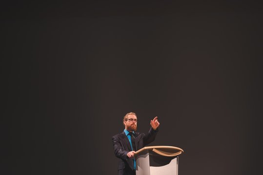Man practicing his speech on stage