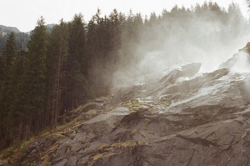 moss covering rocks from waterfall in fog