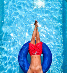 feet and body of a man in the pool on a swim tube, inner tube
