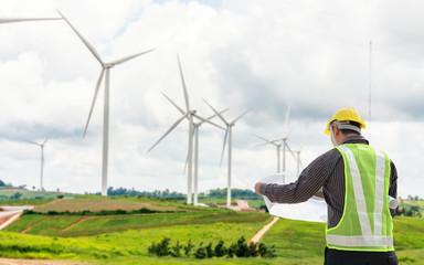 Engineer worker at wind turbine power station construction site