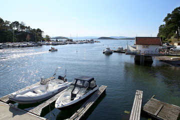 Fototapeta na wymiar Oslo, Norway - July 22, 2018: Motor boats in the harbor in Oslo Fjord. Oslo harbor is located in the inner Oslofjord, just east of the city center. 