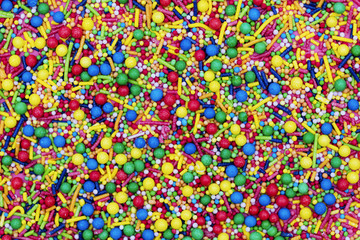 Fototapeta na wymiar Colourful candy cake decorative sprinkles background