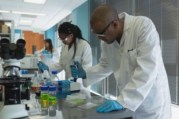 Scientists doing experiment in lab