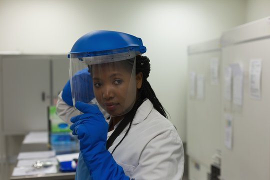 Scientist wearing safety helmet in laboratory