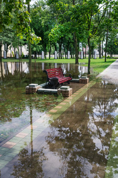 Wooden bench on a spring day, on the flooded city park