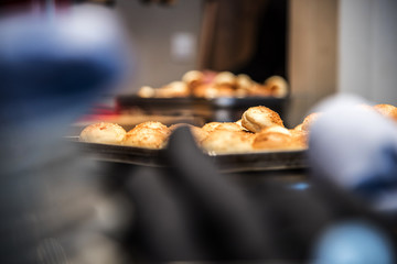 Small bread buns in front of bread close-up with shallow depth of field