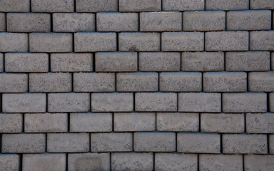 Grey cement road cobblestone texture. Granite stones background laying on one another looking like a wall