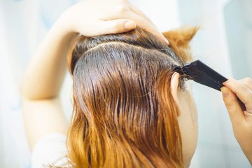 Naklejka premium Woman combing hair