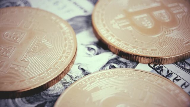 Crypto currency Gold Bitcoin - BTC - Bit Coin. Macro shots crypto currency Bitcoin coins rotating on US dollars.