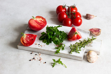 Tomatoes with herbs (parsley and thyme), garlic, salt and pepper. Organic food. Ingredients for preparation tomato juice or soup (gazpacho).