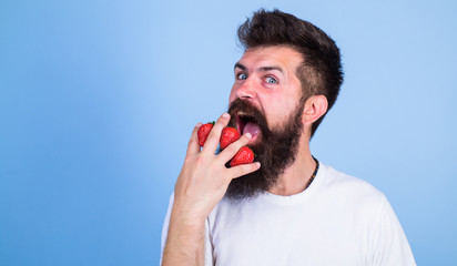 Mostly carbohydrates sucrose fructose glucose. Carbohydrate content strawberry. Metabolic disease. Strawberries safest fruit for sugar levels. Man beard hipster strawberries fingers blue background
