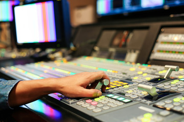 Fototapeta premium Hands on dissolve of Switcher buttons in studio TV station, Audio and Video Production Switcher of Television Broadcast.