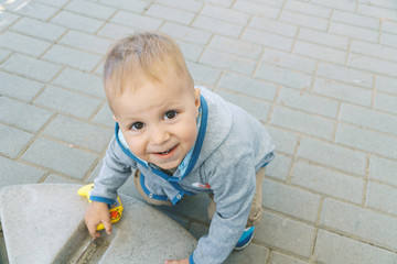 Boy Playing with Toy in Street