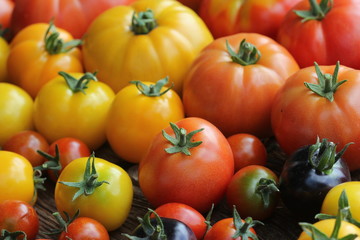 Wooden box filled with fresh vine ripened heirloom tomatoes from farmers market