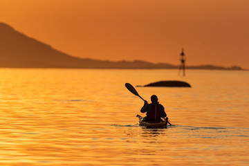 Kayak in sunset at sea