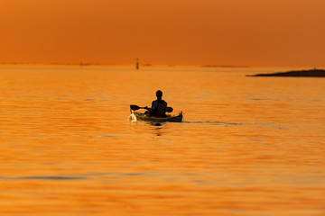 Fototapeta na wymiar Kayak in sunset at sea