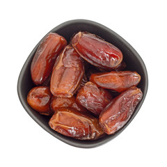 Bowl of dates isolated on white background, top view - festive food.