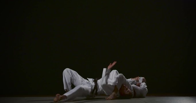 Ju-jitsu duo system technique on black background slow motion 50fps 