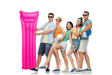 summer holidays and people concept - group of happy smiling friends in sunglasses with beach ball, volleyball, towel, camera and air mattress over white background