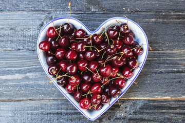Fresh sweet cherry in a heart-shaped plate