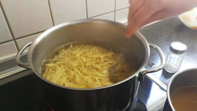 cooking noodles in boiling water in a pot