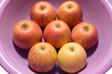 Apples in a light purple net basin
