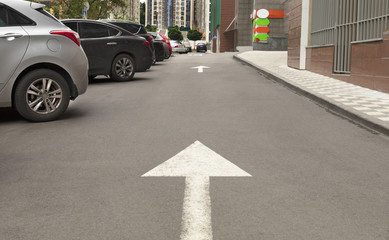 The arrow on the asphalt indicates the direction for the movement of cars