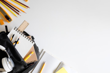 Back to school. Items for the school supplies on white table ready for your design