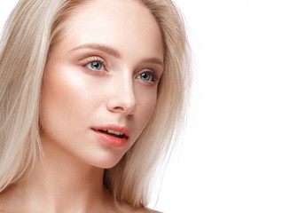 Fototapeta premium Beautiful young girl with a light natural make-up and perfect skin. Beauty face. Picture taken in the studio on a white background.
