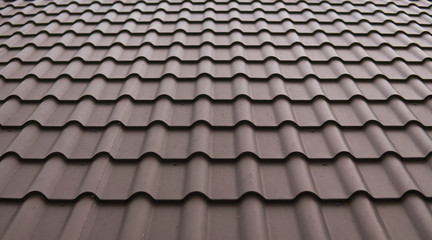 Modern roof covered with tile effect PVC coated brown metal roof sheets.