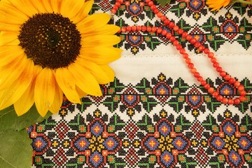Fototapeta na wymiar Ukrainian national folk attributes, sunflower against the background of embroidered cloth