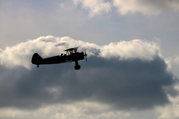 Vintage Biplane Silhouetted Against an Evening Sky