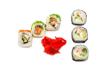 Food abstract background. On the white plane lie rolls or sushi, ginger plates.