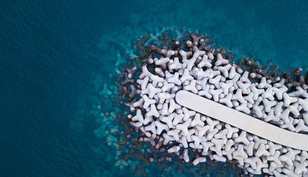 Top view of an abundance of concrete tetrapods.