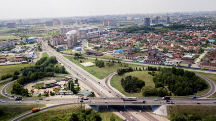 Aerial shot of a car moving on highway overpass, ringway, roundabout