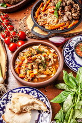 Traditional Uzbek oriental cuisine. Uzbek family table from different dishes for the New Year holiday. The background image is a top view.