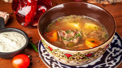 Traditional Uzbek oriental cuisine. soup with lamb meat. Copy space, selective focus