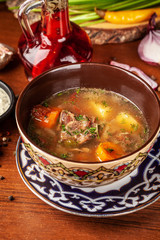 Traditional Uzbek oriental cuisine. soup with lamb meat. Copy space, selective focus