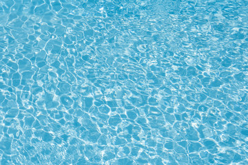 Blue water in pool for background and abstract, Ripple wave with sun reflection in swimming pool, Clean and bright purified water for healthy swimming