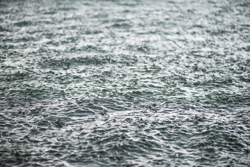 Raindrop impact on rippling water surface