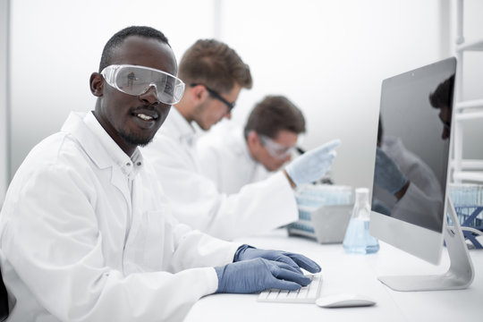 background image of a group of scientists at the laboratory table
