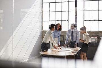 Business team seen through window working together in office