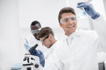 group of young scientists conduct laboratory studies