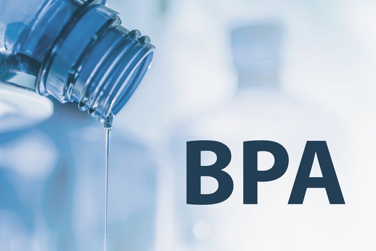 Plastic bottle and liquid stream. Bisphenol, BPA FREE plastic photo