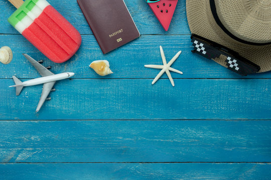 Table top view aerial image of summer & travel beach holiday in the season background concept.Flat lay essentials object accessories for traveler woman on plank blue sea wooden and copy space.