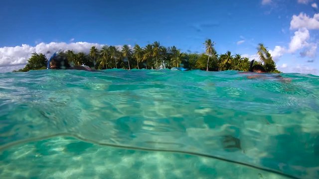 a couple doing snorkeling in a lagoon in French Polynesia