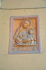 Bologna, Italy, XII century Santo Stefano street old portico wall decoration.(Madonna of the elm)