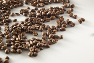 roasted coffee beans poured from clear glass