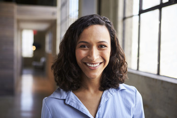 Young mixed race businesswoman smiling to camera