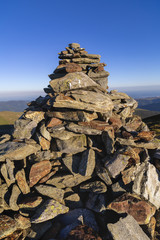 A pile of rocks arranged to mark the top of a mountain